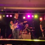 The band performing on stage