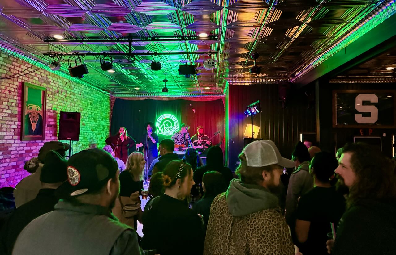 A band plays on stage at Macs Bar