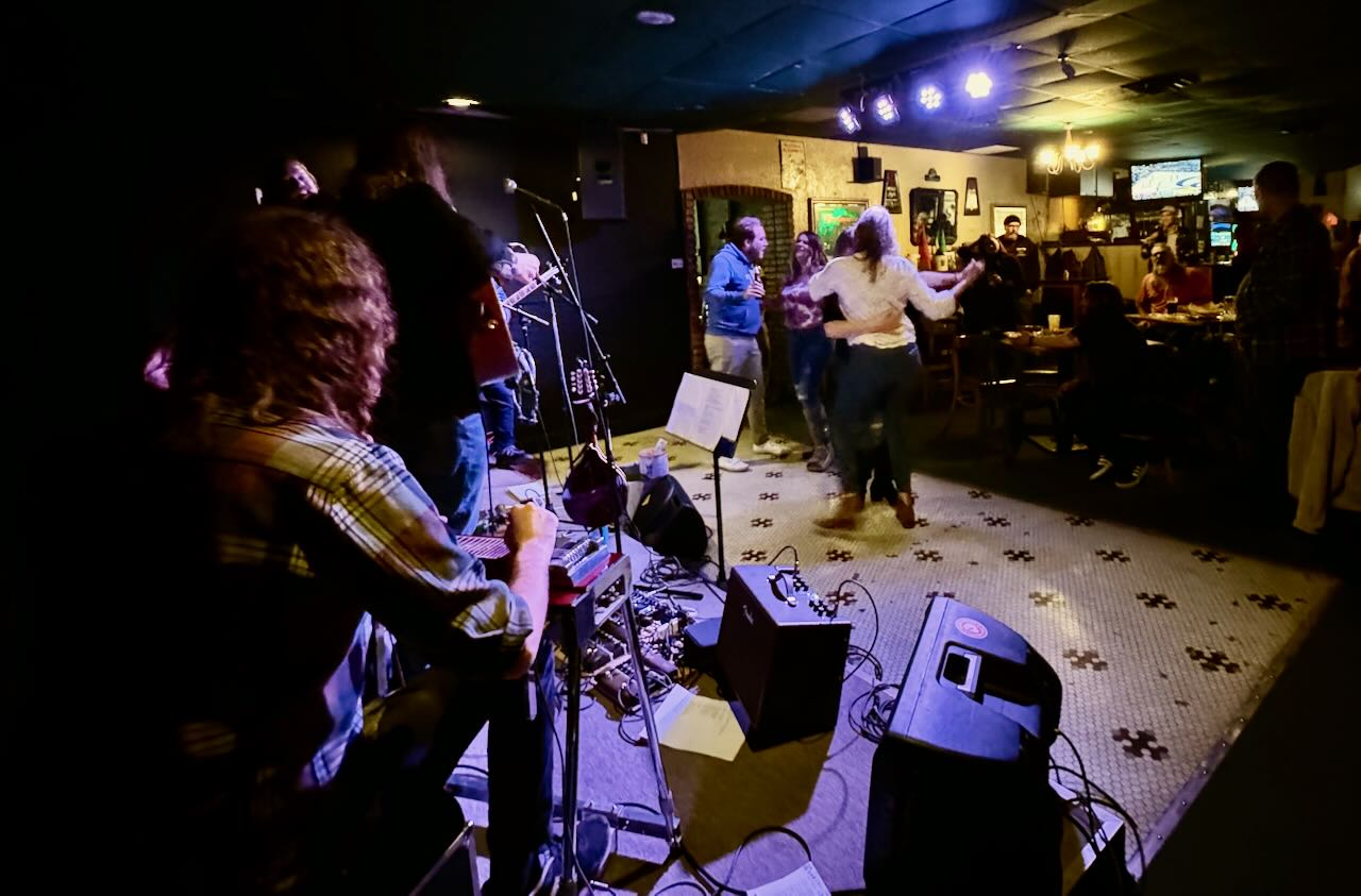 Patrons dance as a band plays on stage at Moriarty's Pub
