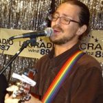 Kaufmann is pictured singing and playing guitar