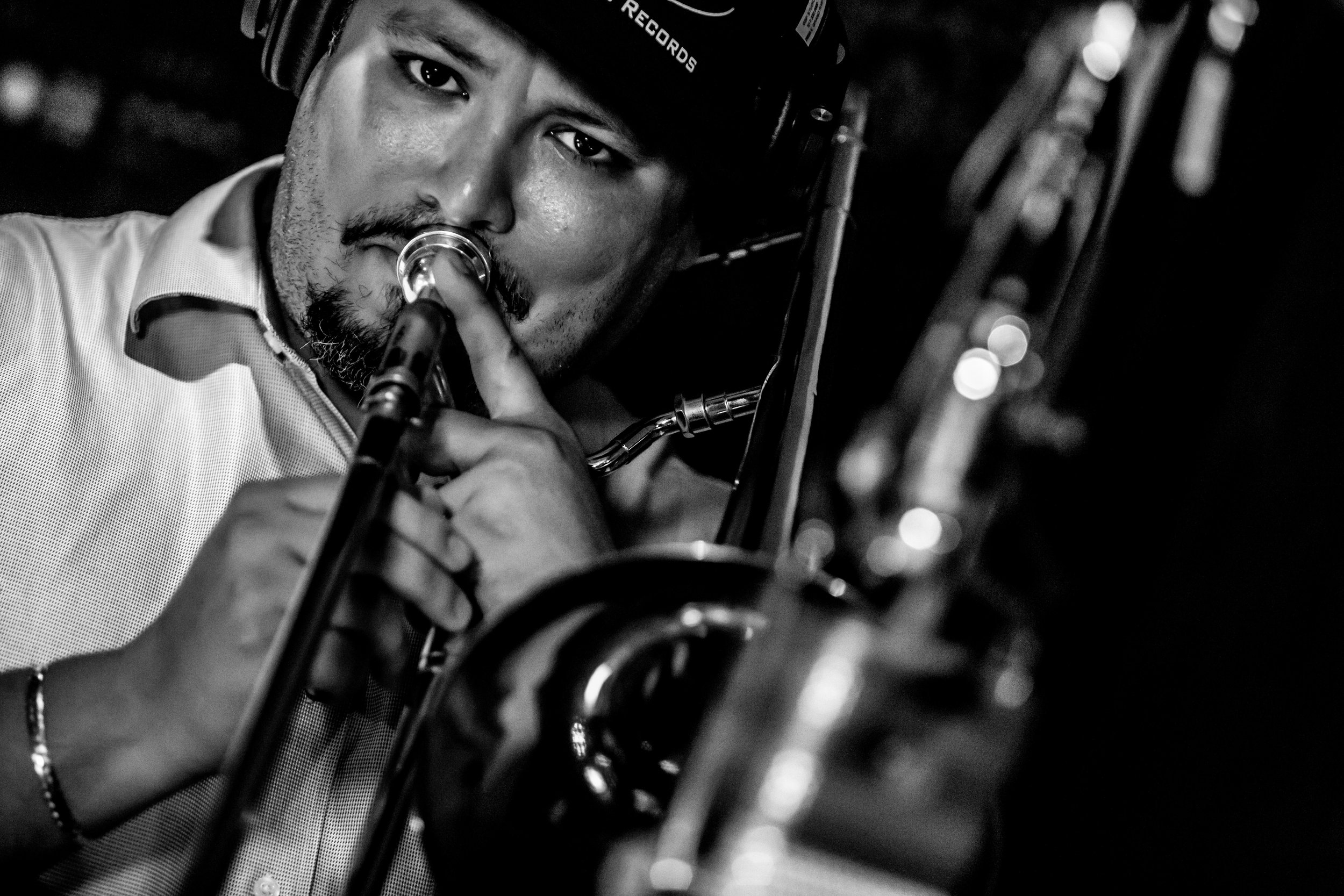 Tight black and white shot of Michael Dease playing trombone