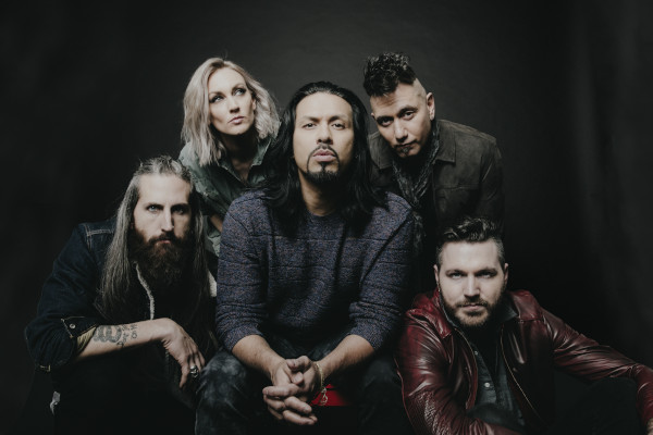 Pop Evil band members pictured on a black backdrop