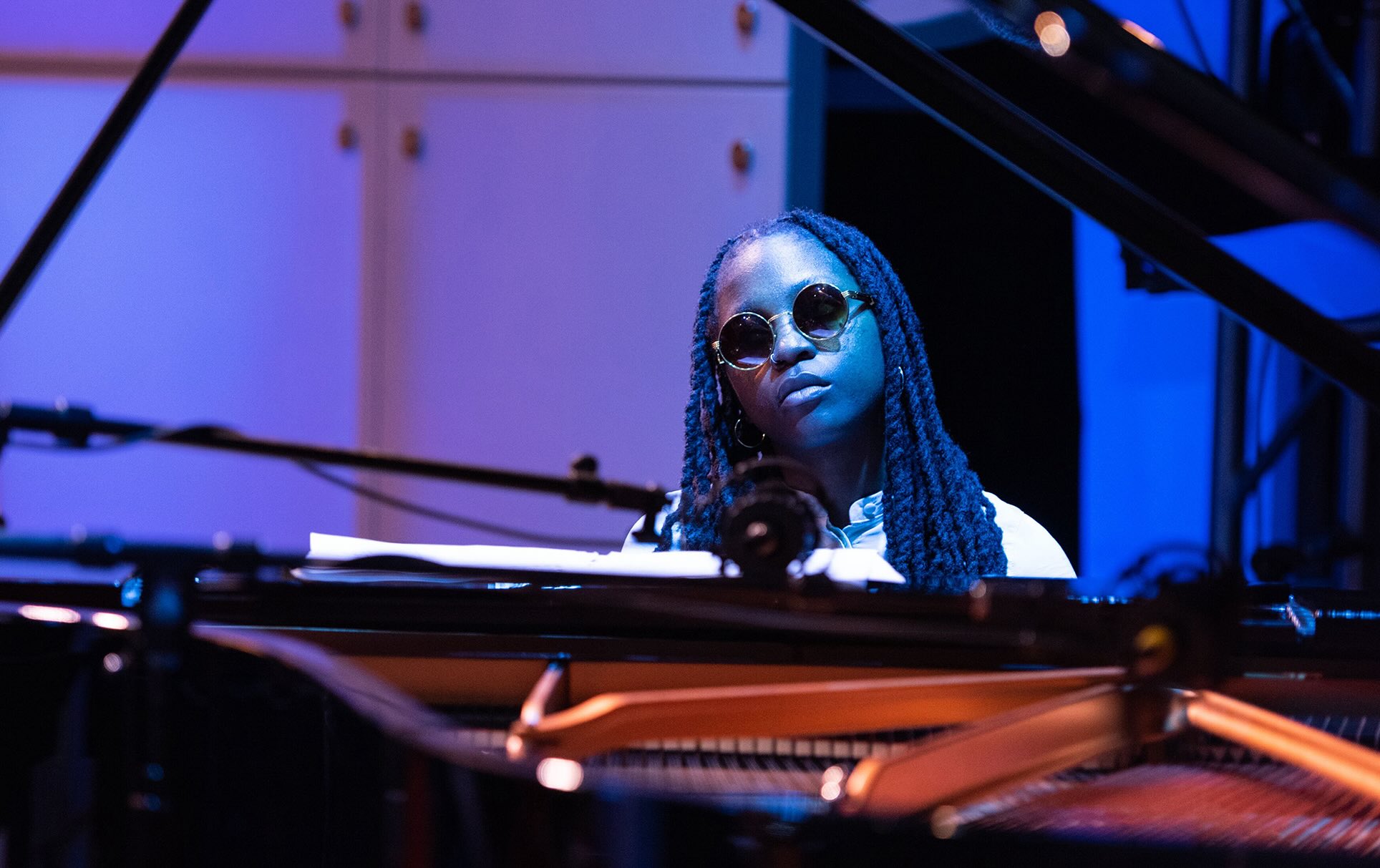 Sequoia is pictured playing a grand piano, viewed through the open piano