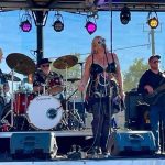 Garner performs on stage with the band.